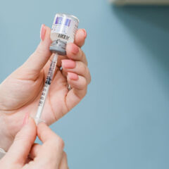 nurse takes injectable from bottle to syringe Jackson Health and Wellness Clinic