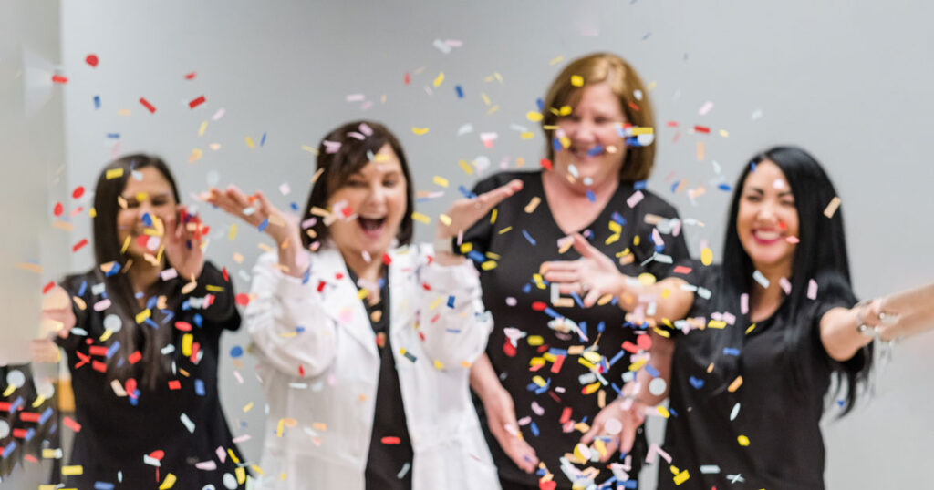 Jackson Health and Wellness Clinic staff throw confetti